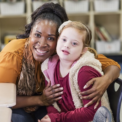 Girl With Down Syndrome and a Teacher In School